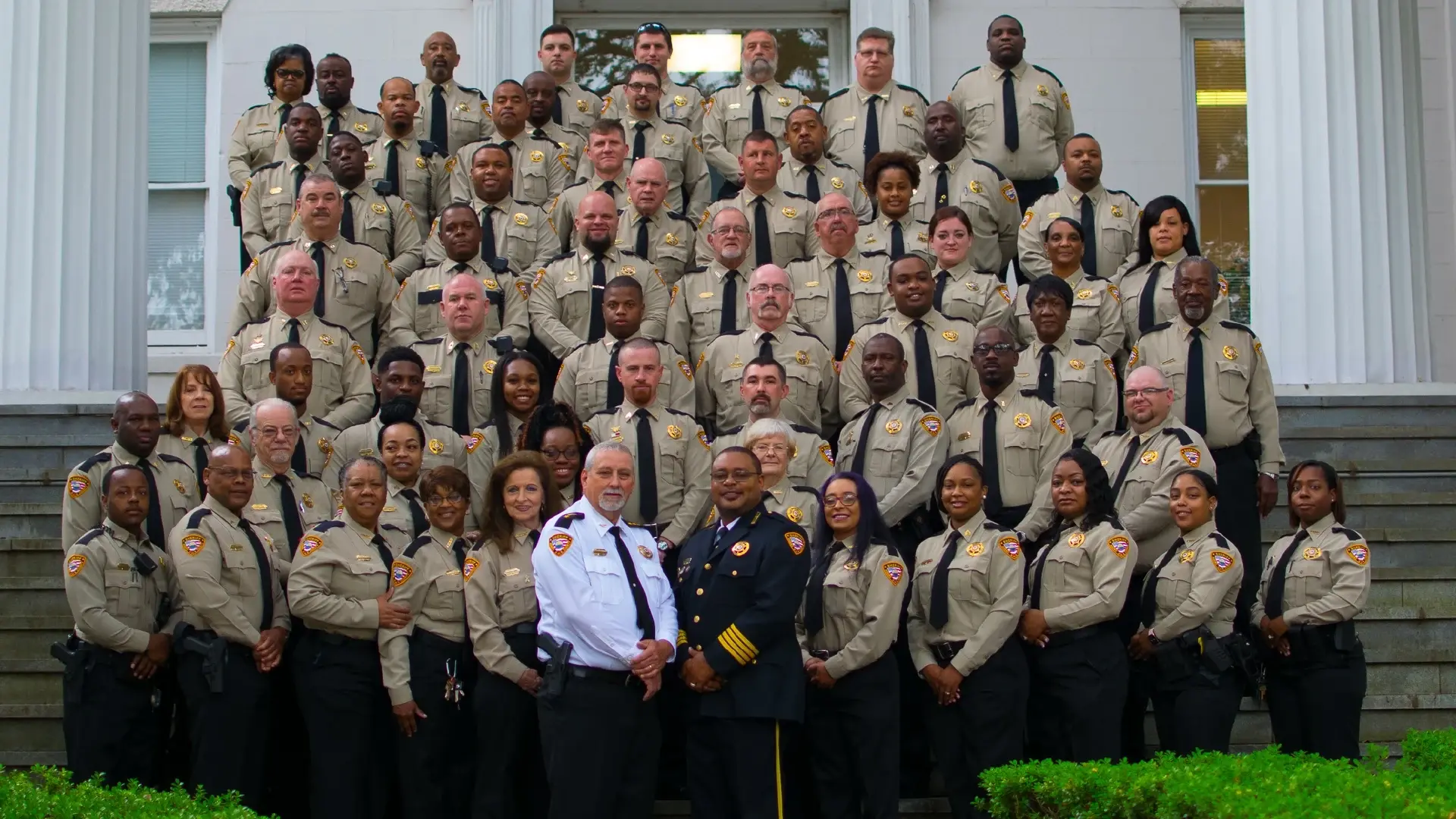 Group photo of the Adams County Sheriff's Office team, featuring law enforcement officers in uniform standing on the steps of a government building.