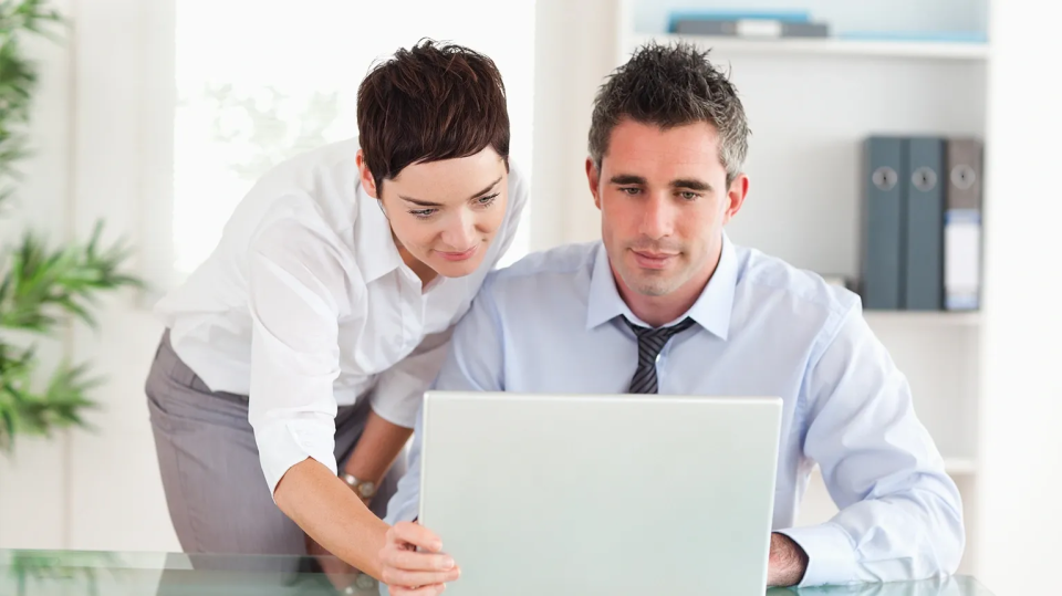 Two persons using a laptop