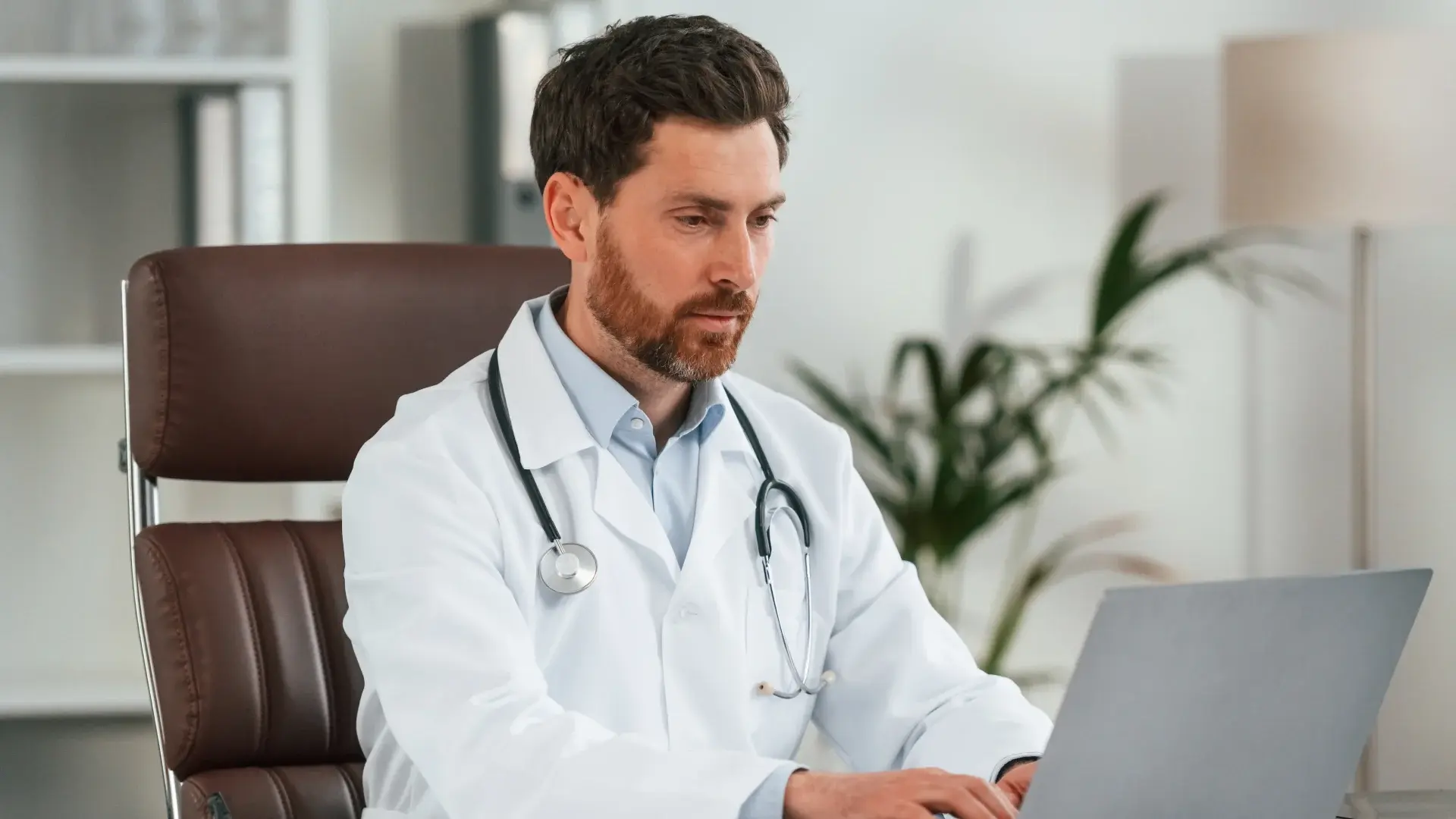 A doctor using a laptop