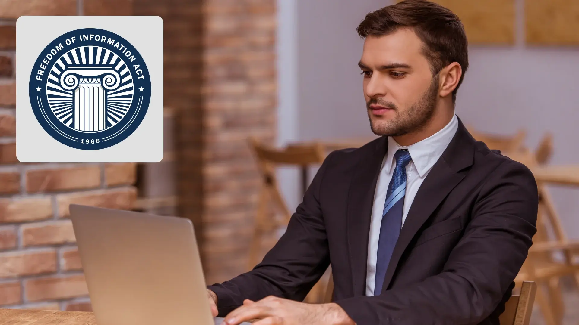 Professional working on a laptop with Freedom of Information Act seal displayed nearby
